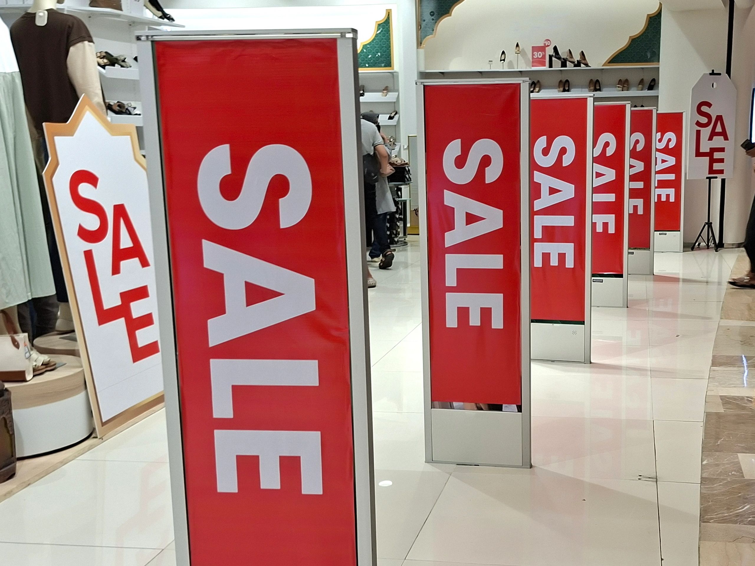 Retail storefront with large promotional sale banners